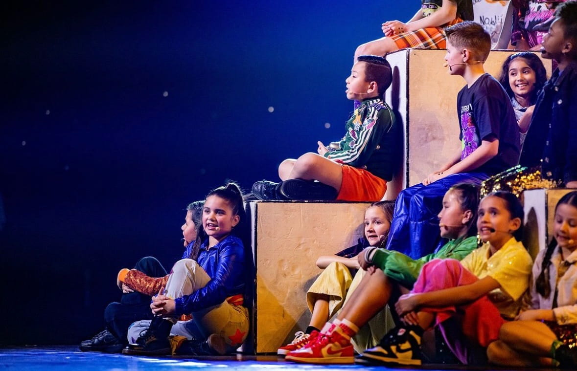 Marisa zingt op podiumblokken met het Kinderen voor Kinderen koor
